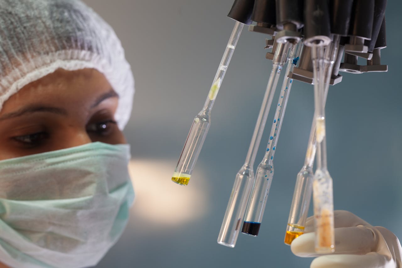 about-img Woman scientist in lab handling test tubes with precision and focus.